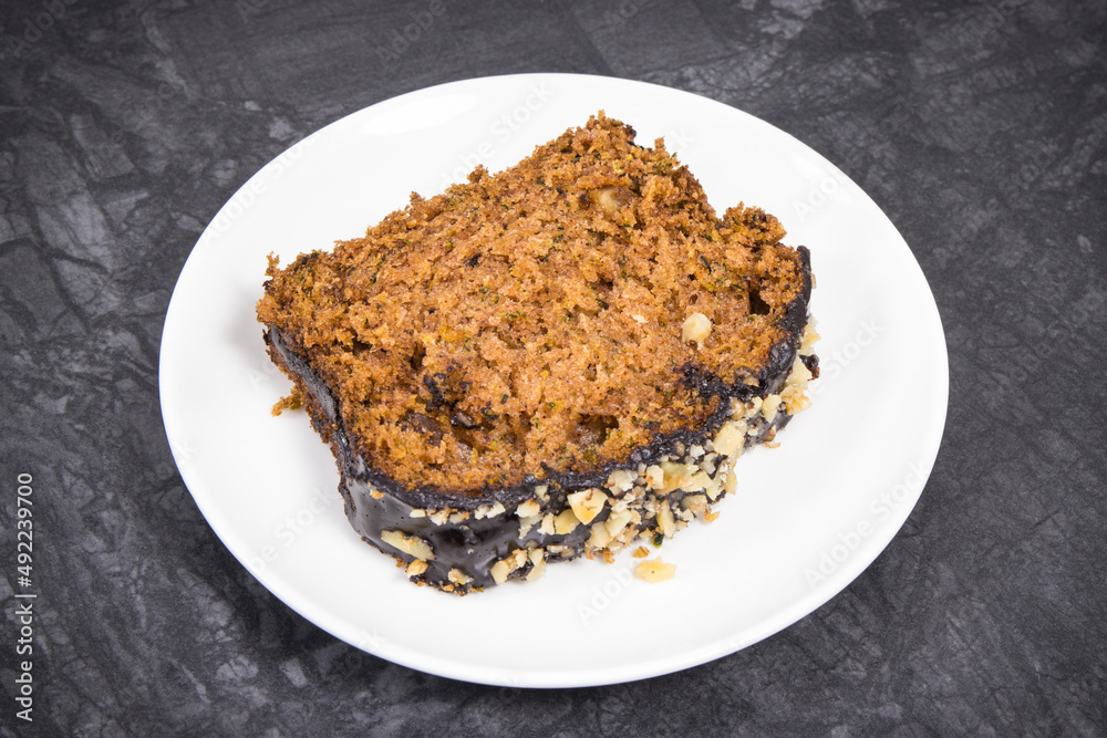 Pastry made of zucchini with nuts and raisin on plate. Delicious dessert Pastry made of zucchini with nuts and raisin on plate. Delicious dessert