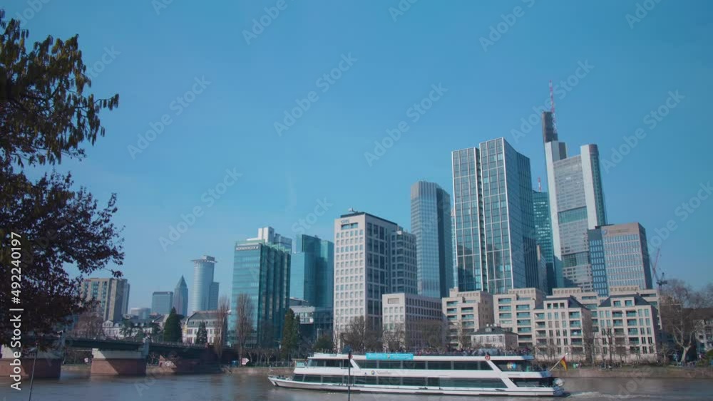 Skyline of Frankfurt am Main with a driving boat on the river main on a sunny day Skyline of Frankfurt am Main with a driving boat on the river main on a sunny day