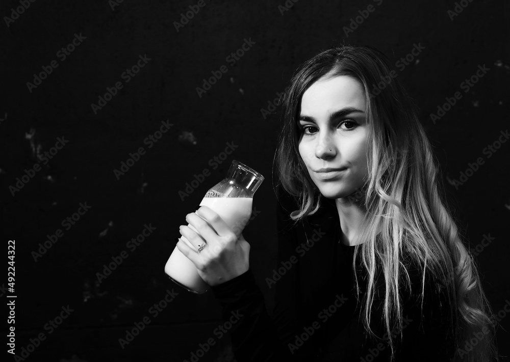 Young girl drinks milk from a bottle Young girl drinks milk from a bottle