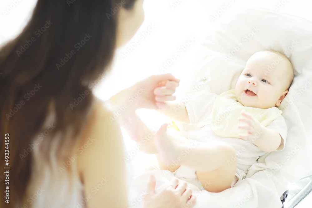 Maternity concept. A young mother feeds her little baby. First lure and breastfeeding. Family in white clothes. Maternity concept. A young mother feeds her little baby. First lure and breastfeeding. Family in white clothes.