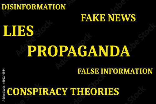 The words propaganda, fake news, disinformation, false information, lies and conspiracy theories in yellow on a black background