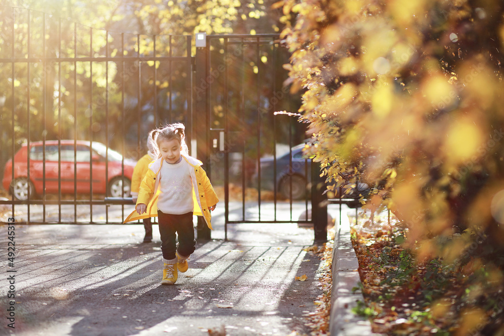 Children walk in the autumn park Children walk in the autumn park
