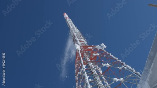 snow falling from tv transmitter pole