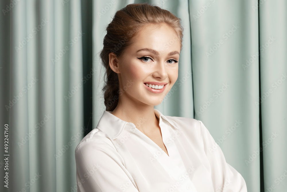 Stylish happy young caucasian blond woman with perfect make up, healthy skin smiling, posing on background of green curtains. Natural womens beauty concept, skincare products advertising. Stylish happy young caucasian blond woman with perfect make up, healthy skin smiling, posing on background of green curtains. Natural womens beauty concept, skincare products advertising.