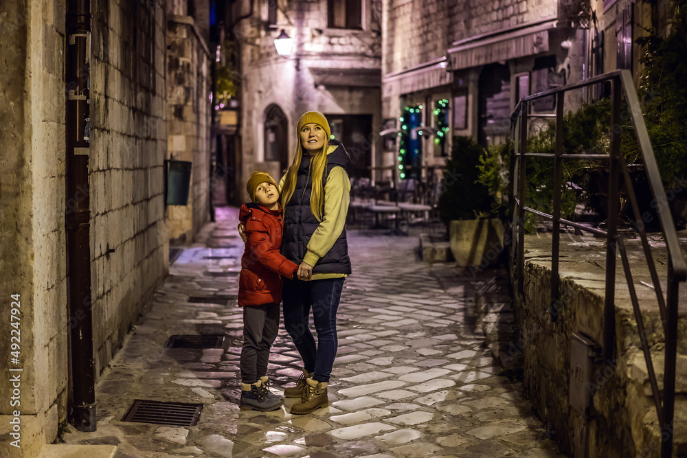 Mom and son travelers in Montenegro in Kotor Old Town Ladder of Kotor Fortress Hiking Trail. Aerial drone view