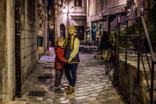 Mom and son travelers in Montenegro in Kotor Old Town Ladder of Kotor Fortress Hiking Trail. Aerial drone view © galitskaya