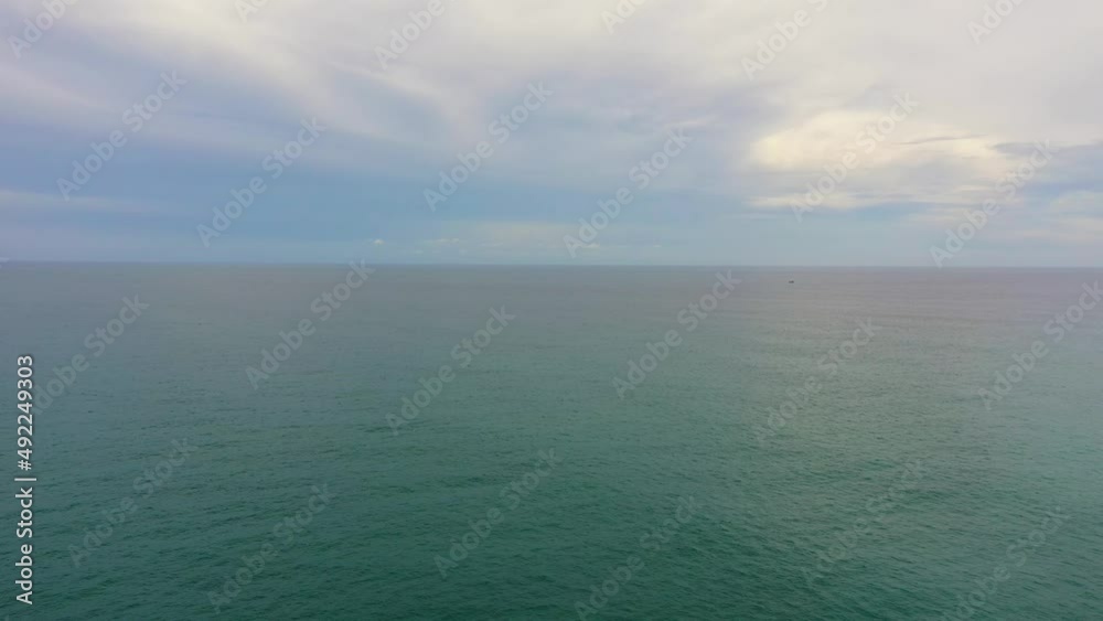 Aerial Seascape: Blue sea and sky with clouds.