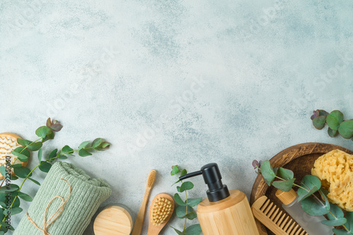 Zero waste concept. Body care products with eucalyptus branches on gray concrete background. Top view, flat lay photo