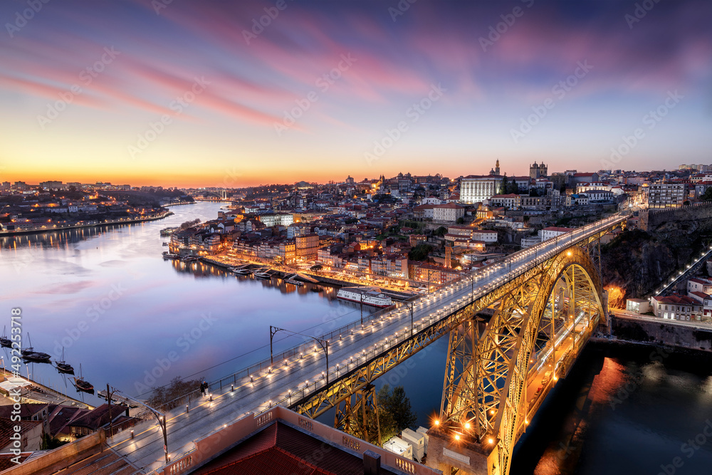Porto, Portugal. Panoramic cityscape of Porto, Portugal - in front the famous Luis I Bridge and the Douro River during dramatic sunset