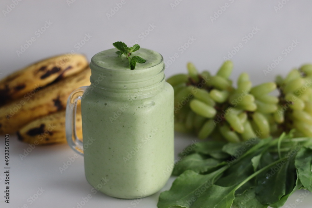 Green smoothie made of frozen green grapes, fresh baby spinach, bananas and almond milk. Served in mason jar Green smoothie made of frozen green grapes, fresh baby spinach, bananas and almond milk. Served in mason jar