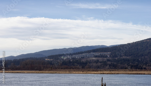 Scenic Nature Mountain Landscape View by Pitt River during a sunny winter day. Taken in Pitt Meadows, Vancouver, British Columbia, Canada.