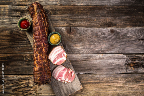 Slices of bacon on a wooden background. Brisket. banner, menu, recipe place for text, top view
