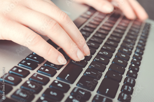 Woman using laptop, searching information on the Internet, having a workplace at home, Vintage concept, remote work, quarantine at home, hands on the keyboard, press a key, banner, copy space, concept