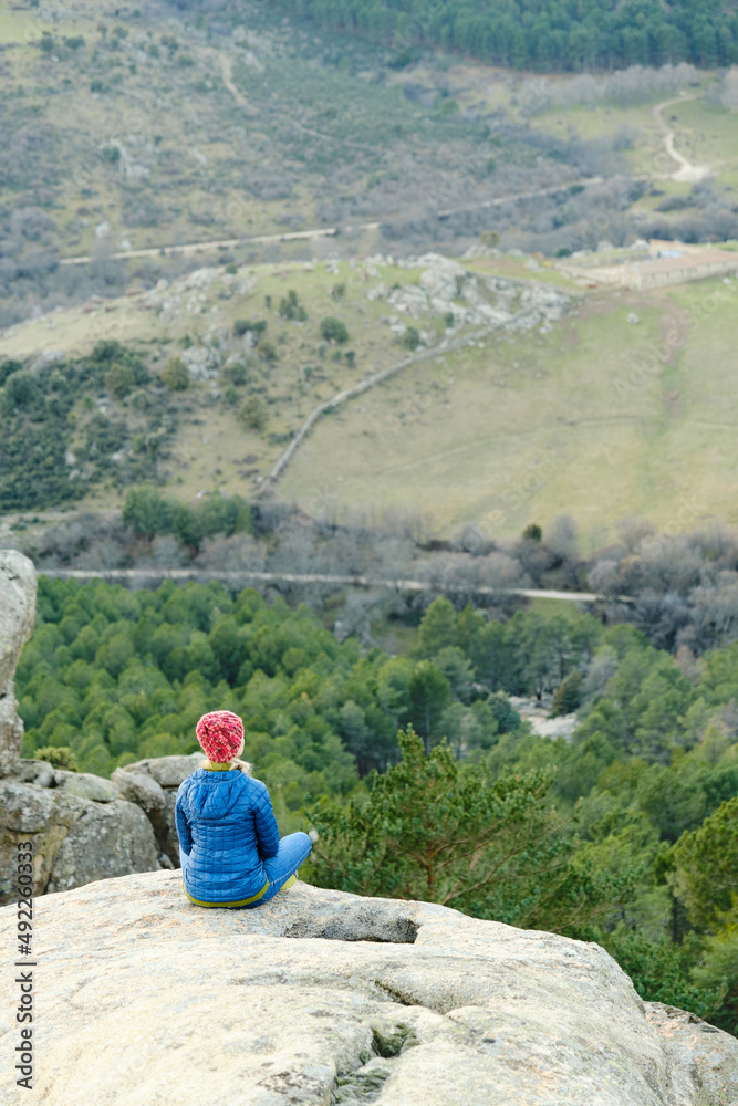 A Woman practicing meditation in the mountains.