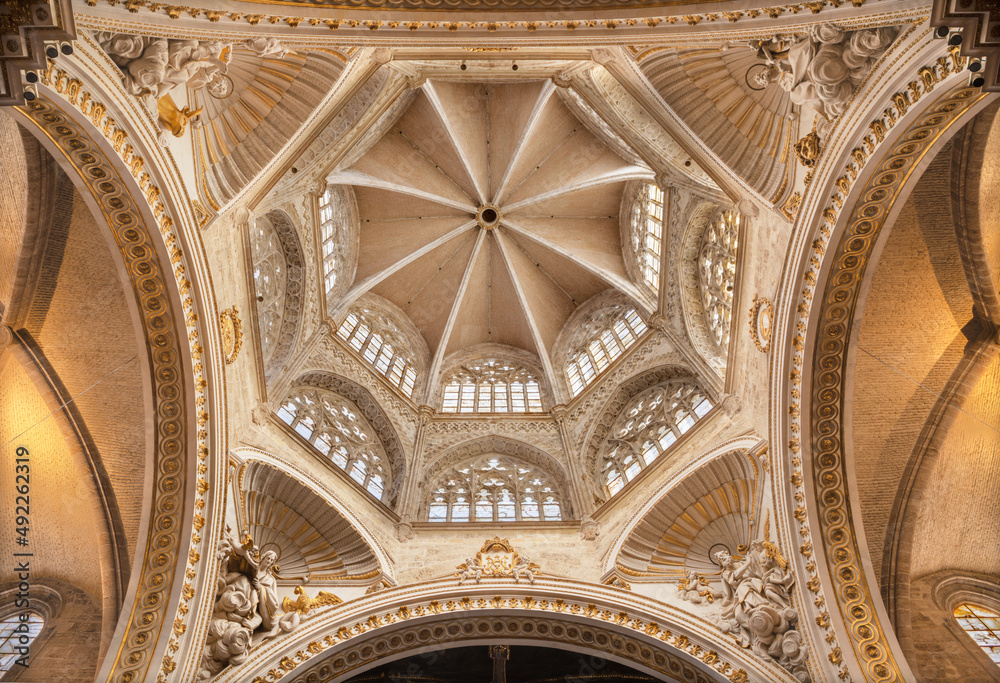 VALENCIA, SPAIN - FEBRUARY 14, 2022: The gothic cupola of the Cathedral with the baroque statue of Evangelist.