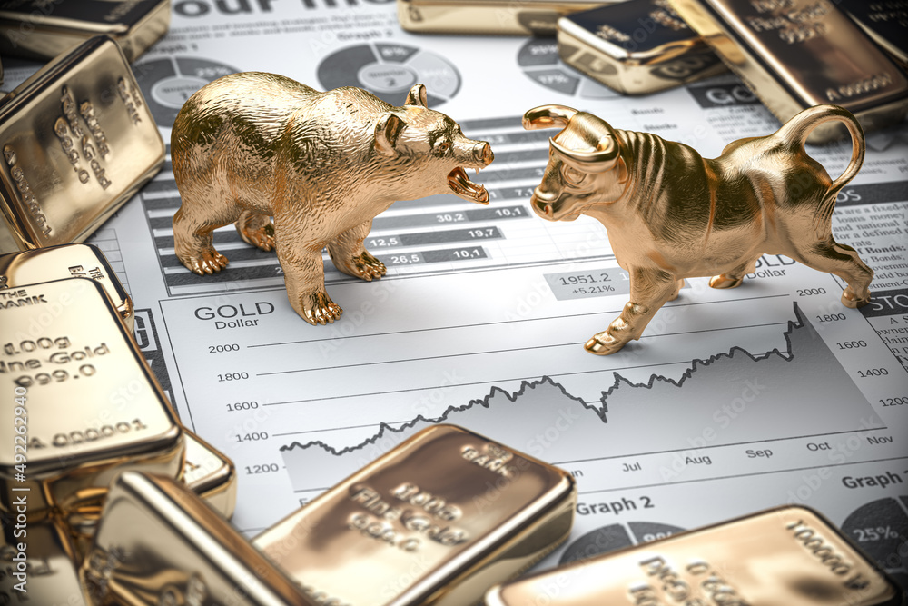 Golden bars and ingots of gold with bull and bear on stock chart