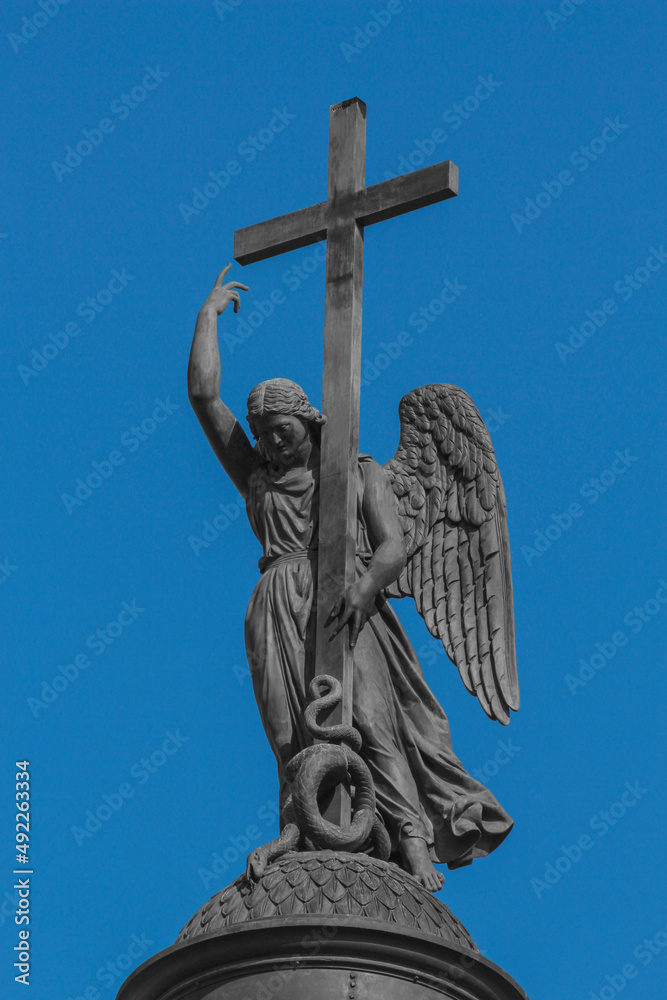 Sculpture of an angel with a cross on the Alexander Column in St. Petersburg Sculpture of an angel with a cross on the Alexander Column in St. Petersburg
