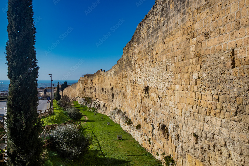 Tarquinia, Viterbo, Lazio, Italy - The ancient walls of fortification and defense, which enclose the historic center of the city. Defensive wall, high and resistant, built in bricks.