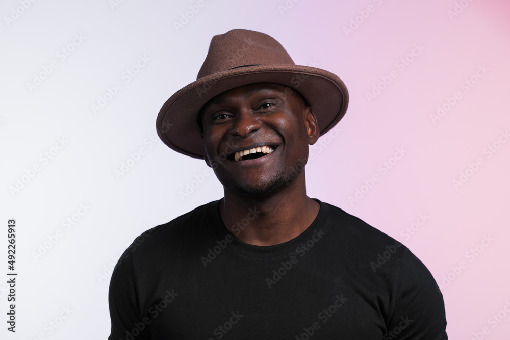 Smiling happy american african man wear stylish hat on white background. Festive and party concept Smiling happy american african man wear stylish hat on white background. Festive and party concept