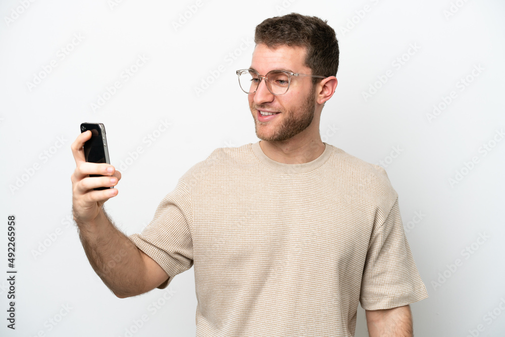 Young caucasian man isolated on white background making a selfie Young caucasian man isolated on white background making a selfie