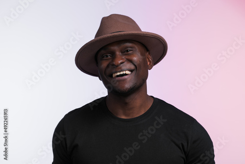 Smiling happy american african man wear stylish hat on white background. Festive and party concept
