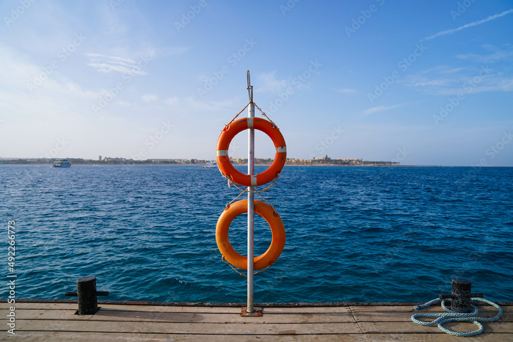 Lifebelt on a jetty in the middle of the Red Sea in Makadi Bay, Hurgharda, Egypt