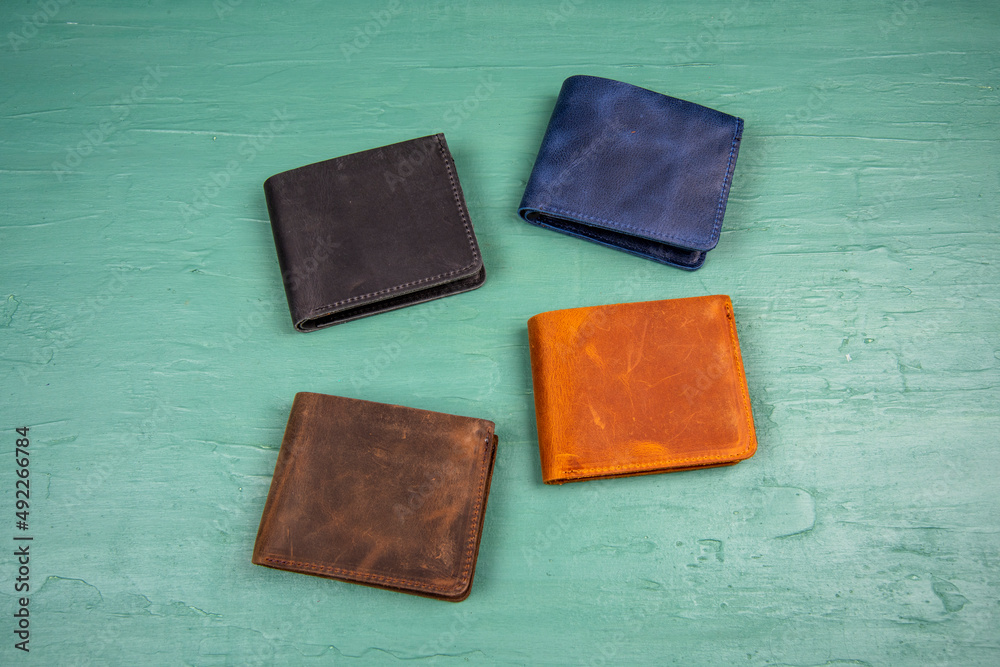 colorful handmade leather wallets on green table men style fashion