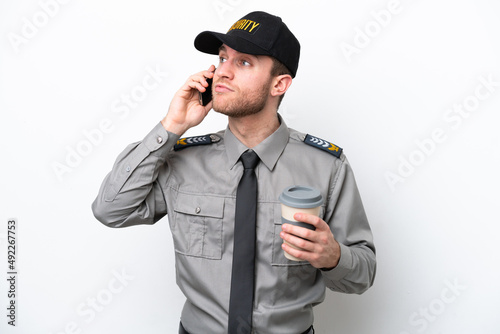 Young safeguard caucasian man isolated on white background holding coffee to take away and a mobile