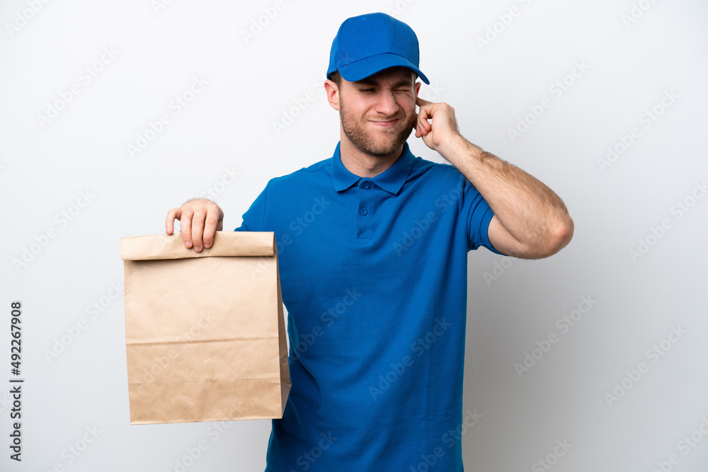 Delivery caucasian man isolated on white background frustrated and covering ears Delivery caucasian man isolated on white background frustrated and covering ears