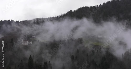 4k time lapse. Mist cloud moving fast over the forest. photo