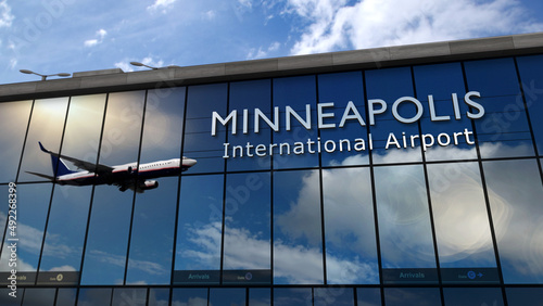 Airplane landing at Minneapolis Minnesota, USA airport mirrored in terminal photo