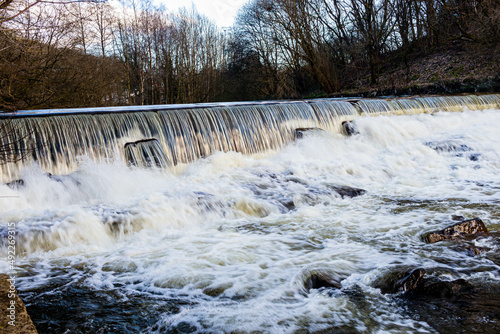 low waterfall on the roch river in heywood from a different perspective