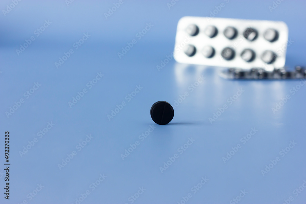 A pill of charcoal , macro, it helps break up the bubbles in gas and