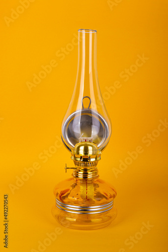 Fotografie Old kerosene lamp on yellow ground