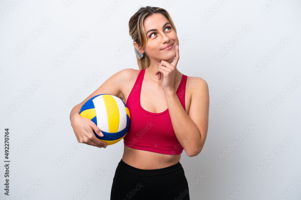 Young caucasian woman playing volleyball isolated on white background thinking an idea while looking up Young caucasian woman playing volleyball isolated on white background thinking an idea while looking up