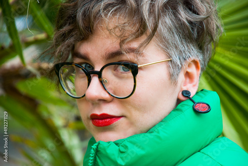 Portrait of beautiful woman with glasses and red lopstick. photo