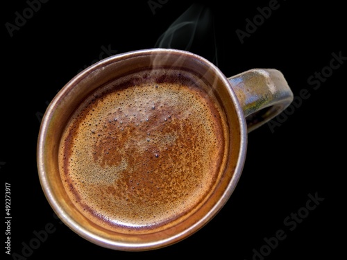 Cup of coffee view from the top against black background