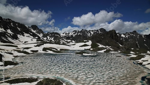 Wallpaper Mural 4K Time Lapse. Glacial lake on top of snowed mountains. Clouds Time Lapse. Torontodigital.ca