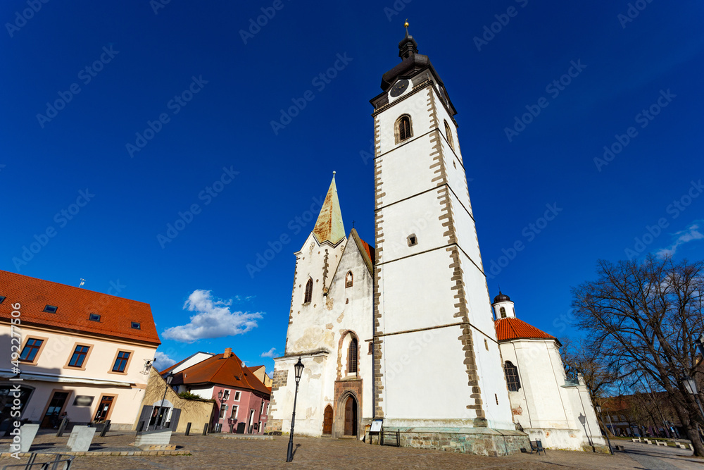 Gothic church of the Nativity of the Blessed Virgin Mary and clock tower. Pisek - town in South Czechia.