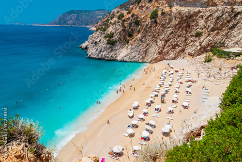 Fototapeta Naklejka Na Ścianę i Meble -  Aerial View From Flying Drone Of People Crowd Relaxing On Beach. Swimming people in sea. Top view of Kaputas Beach between Kas and Kalkan