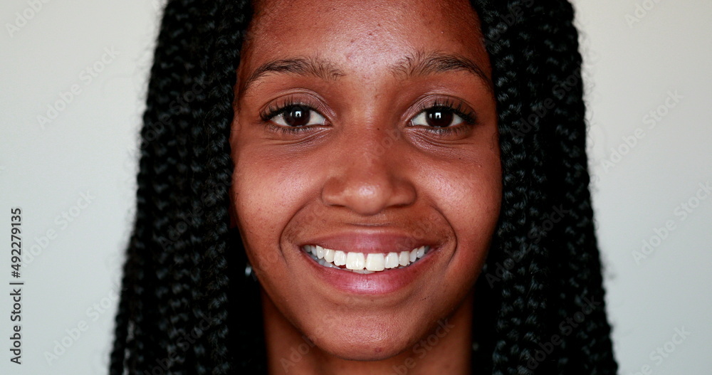 Young black woman smiling at camera, Portrait African American girl portrait face close-up smile Young black woman smiling at camera, Portrait African American girl portrait face close-up smile