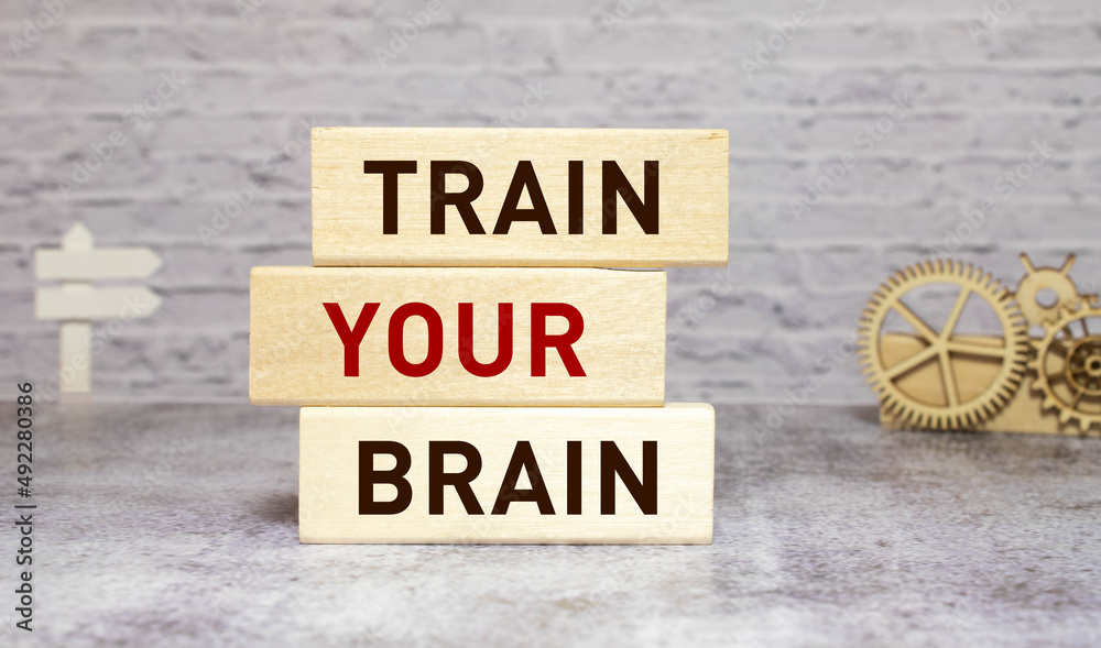 Fototapeta premium An image of plastic letters saying use your brain. Image is taken against a wooden table