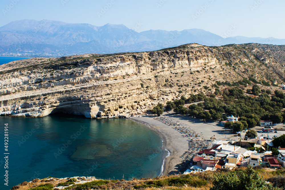 Top view of the coast, rocky slope on the beach of Matala, island of Crete, Greece. Historic Sites. Popular tourist destination