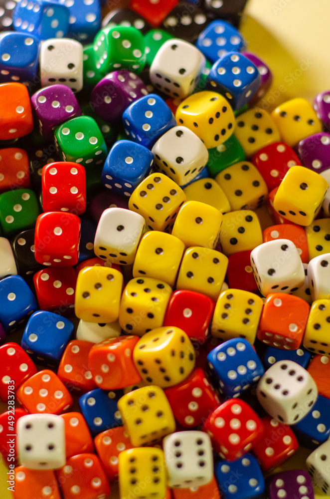 Many six-sided dice of different colors Many six-sided dice of different colors