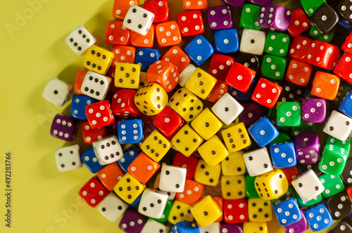 Top view of dozens of six-sided dice of many colors