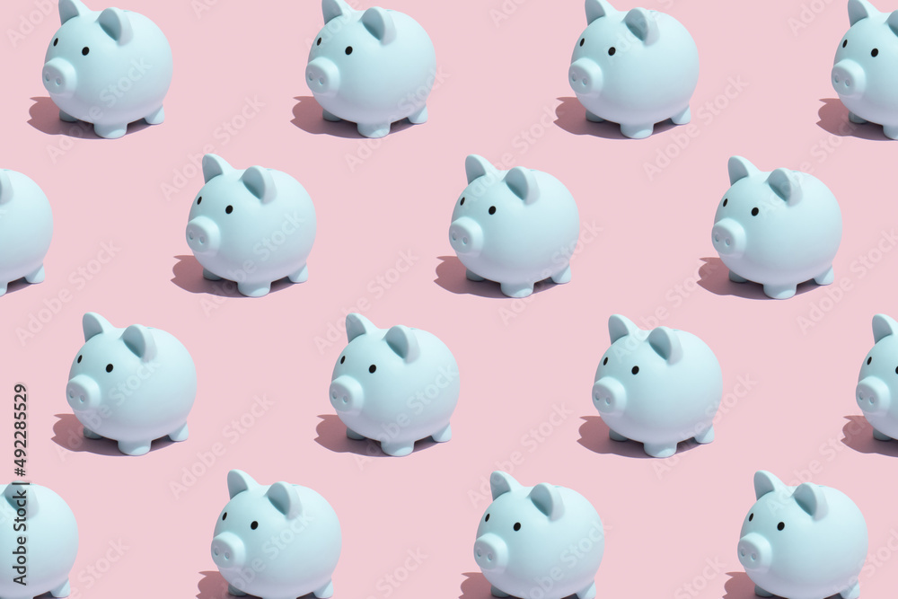 Seamless pattern made of pastel blue piggy banks on pink background. Concept of saving, accumulating and preserving money. Seamless pattern made of pastel blue piggy banks on pink background. Concept of saving, accumulating and preserving money.