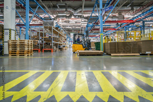 Wide warehouse interior with shelves and pallets