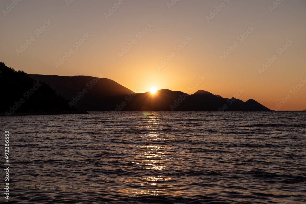 the outline of the mountains at sunset, the shore of the adriatic sea in croatia, summer sunset by the sea the outline of the mountains at sunset, the shore of the adriatic sea in croatia, summer sunset by the sea