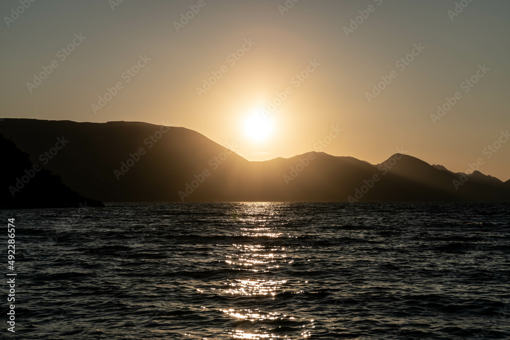 the outline of the mountains at sunset, the shore of the adriatic sea in croatia, summer sunset by the sea