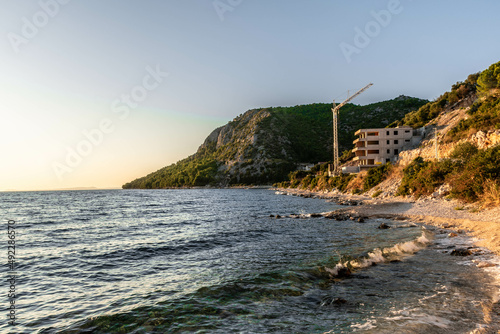 Fototapeta Naklejka Na Ścianę i Meble -  the outline of the mountains at sunset, the shore of the adriatic sea in croatia, summer sunset by the sea